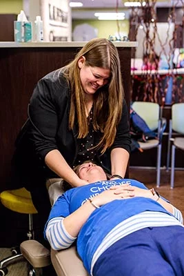 Chiropractor Crown Point IN Kelsi Dimitt with a Patient