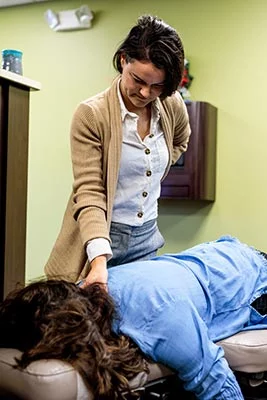 Chiropractor Crown Point IN Kristina Kauffman Focusing on Her Patient