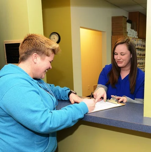 Receptionist Greeting Patient at Kauffman Chiropractic - Merrillville